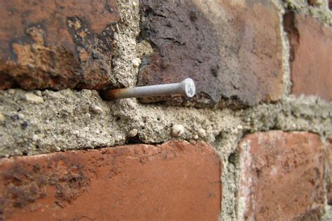 How to Hang Art on Brick Wall: A Symphony of Nails and Mortar